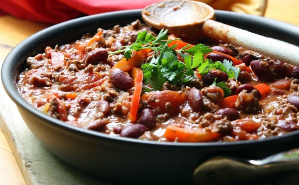 A pan of chilli, ready to serve.  Soft focus, shallow depth of field.